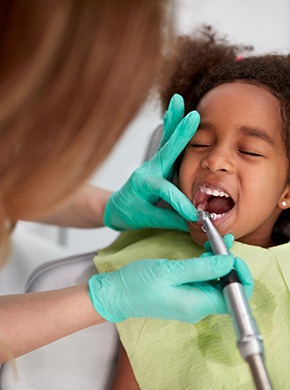child having their teeth cleaned by a dentist in Manchester