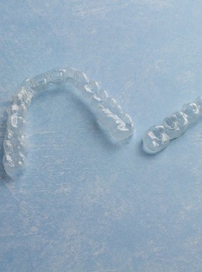 A pair of clear aligners resting on a table