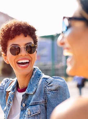 Woman smiling outside with her friend